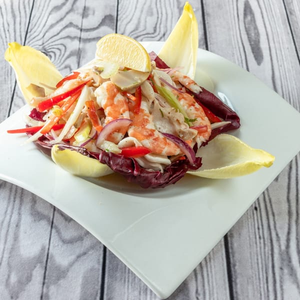 Luciano's Ristorante & Lounge's seafood salad with shrimp, calamari, red peppers, and lemon.