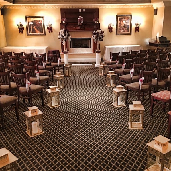 Luciano's Ristorante & Lounge event space set up for a ceremony with chairs and lanterns.