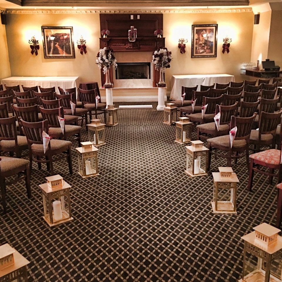 Luciano's Ristorante & Lounge event space set up for a ceremony with chairs and lanterns.