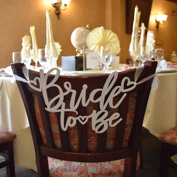 A "Bride to Be" sign adorns a chair at a set table in Luciano's Ristorante & Lounge.