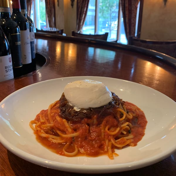 Spaghetti with red sauce, braised short rib, and a large dollop of burrata cheese.