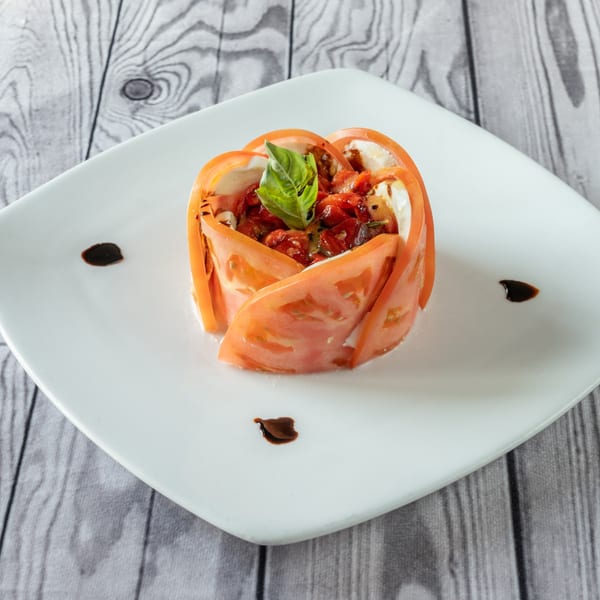 Luciano's Ristorante & Lounge's Italian caprese salad with tomato slices, mozzarella, and basil.