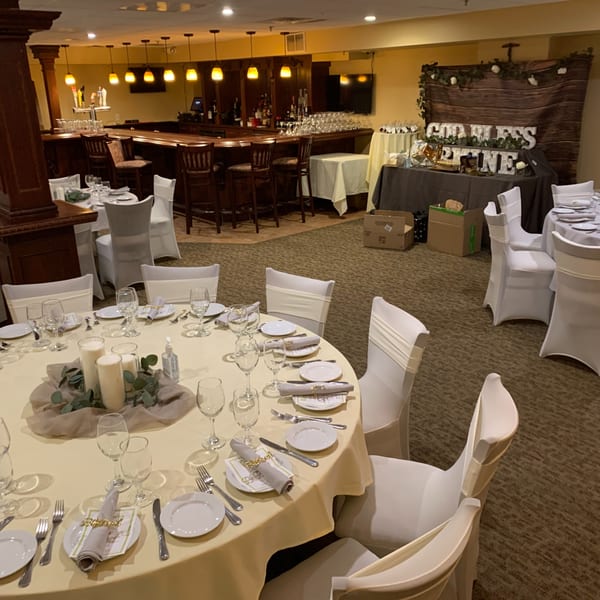 Luciano's Ristorante & Lounge dining room set up for an event with a bar and decorated tables.
